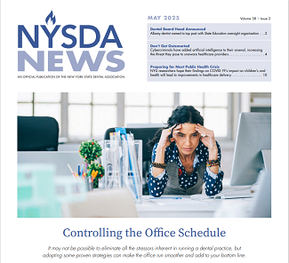 Woman sitting at desk with head in hands