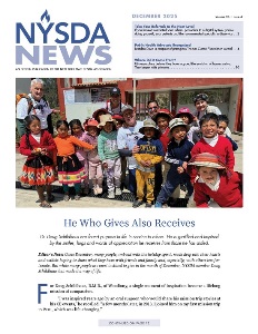 Group of small children standing with gray haired man