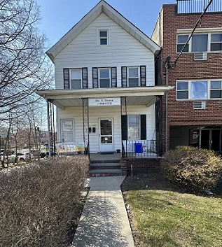 white 2 story building with walkway and grass